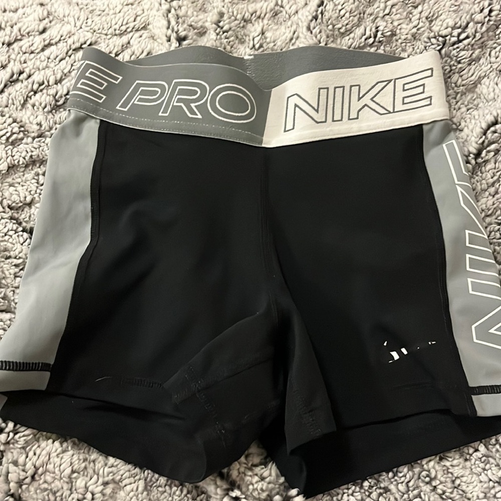Gray, white and black Nike pros